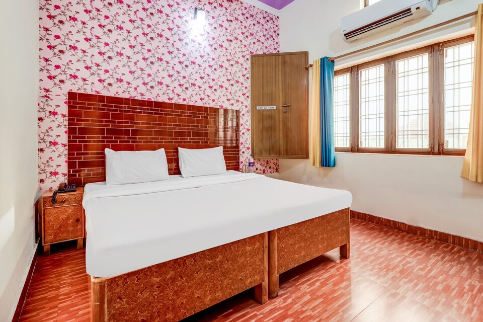 Family double bed room with floral wallpaper and wardrobe